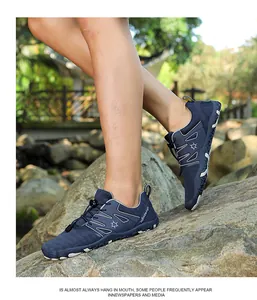 Detailed shot of breathable blue outdoor sports shoes worn on rocks during a nature hike