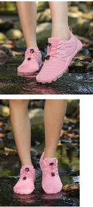 Detail of pink breathable non-slip outdoor wading shoes in a natural stream setting