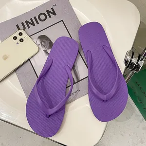 Detailed macro view of purple anti-slip flip-flops with comfortable thong straps.