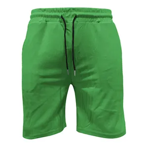 Detail of green corduroy drawstring shorts with vertical rib texture and elastic waist.