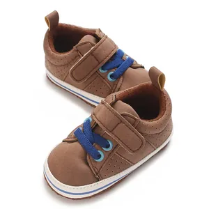 Brown infant walking shoes with decorative blue laces and hook-and-loop strap detail