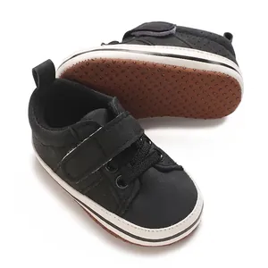 Detailed view of black baby pre-walker sneakers featuring non-slip soft dotted soles