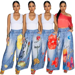 Detailed view of women's wide-leg pants with artistic digital floral and butterfly prints