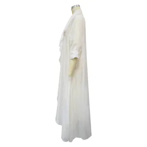 Close-up side profile of lightweight white chiffon cardigan on garment dress form