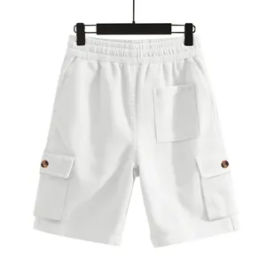Detail view of white corduroy cargo shorts featuring side pockets and elastic waist