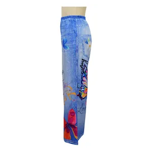 Detailed side view of blue denim-print wide-leg trousers featuring vibrant butterfly patterns
