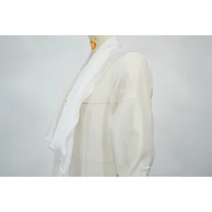 Close-up detail of lightweight white long-sleeved chiffon cardigan for sun protection