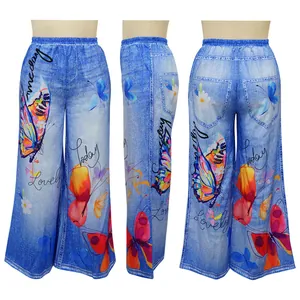 Detailed view of blue denim print wide-leg trousers featuring butterfly and text motifs.