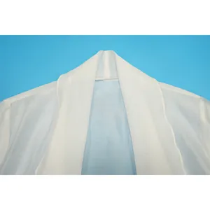 Detail view of the collar and shoulder stitching on a lightweight white chiffon cardigan