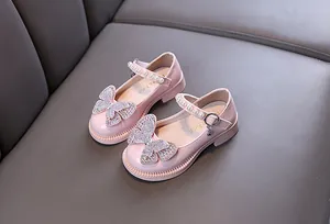 Detail view of pink princess shoes for girls with rhinestone butterfly and pearls