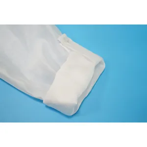 Detailed macro view of a white chiffon shirt sleeve cuff with a single button.