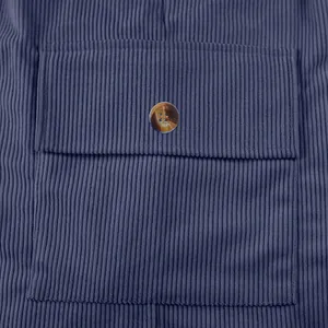 Detailed close-up of a blue corduroy cargo pocket featuring a flap and decorative marbled button