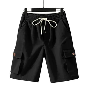 Full detail of black corduroy cargo shorts with elastic drawstring waist and side pockets.