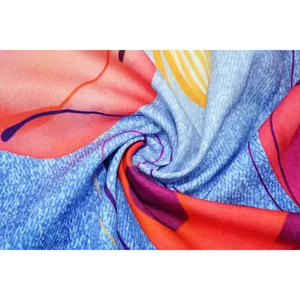Macro detail of vibrant abstract floral print fabric with soft drape and rich texture.