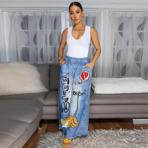 Stylish wide-leg pants with graffiti print paired with a white ribbed tank top