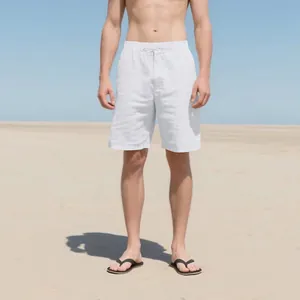 Men's loose white linen shorts for summer beach casual wear shown on model in detail