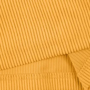 Macro detail of mustard yellow heavyweight corduroy fabric texture with reinforced stitching
