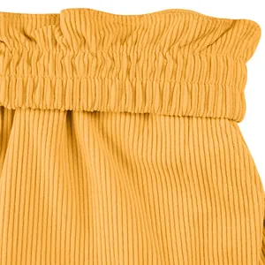 Close-up macro view of yellow corduroy shorts with a pleated elastic waistband design.