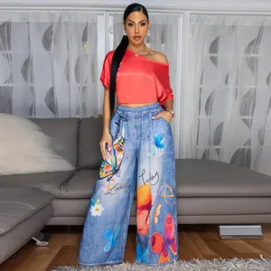 Women's chic red off-shoulder top paired with butterfly print wide-leg pants.