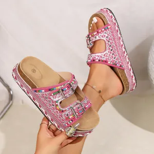 Detailed view of pink platform sandals with colorful beads and sparkly rhinestones.