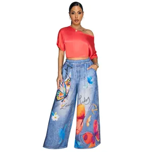 Detailed view of women's butterfly print wide-leg pants and coral one-shoulder top
