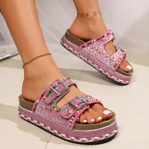 Close-up of pink platform slides with colorful beads and rhinestone double buckles.