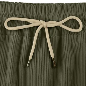 Detailed macro shot of olive green corduroy shorts waistband featuring a cream drawstring