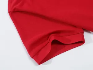 Macro view of red breathable piqué polo shirt sleeve texture with ribbed cuff detail.