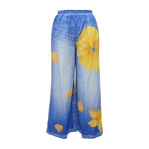 Front view of women's wide leg trousers with blue denim print and yellow floral patterns