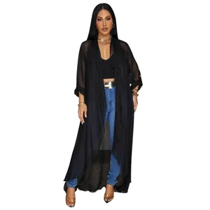 Macro view of a lightweight long black chiffon cardigan with an elegant open front