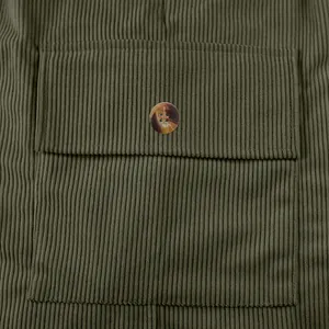 Close-up of olive green corduroy cargo shorts pocket with marble button detail