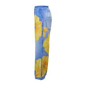 Side view of wide-leg casual pants featuring blue denim print and large yellow flowers