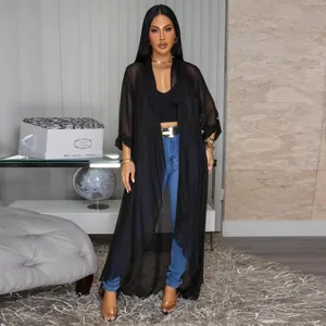 Full body shot showing the flowy drape of the black sheer chiffon long cardigan.