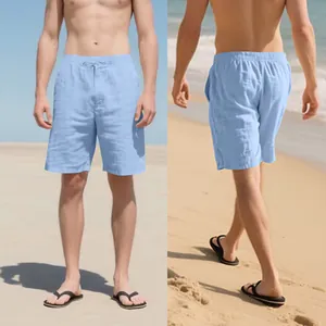 Macro view of light blue linen shorts showing fabric texture and drawstring waist