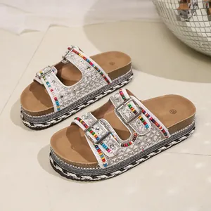 Colorful beaded platform sandals with rhinestones and double buckles on a cork sole.