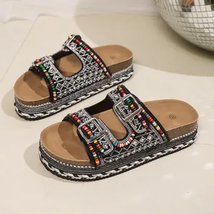Close-up of bohemian platform sandals with colorful beads and sparkly rhinestones