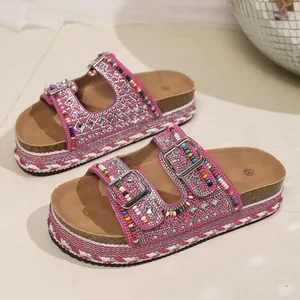 Detailed view of pink bohemian platform sandals with colorful beads and rhinestone buckles.