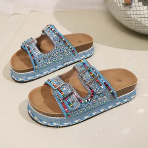 Detailed view of boho platform slide sandals with blue rhinestones and colorful beads decoration