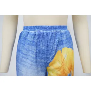 Close-up of printed wide-leg pants featuring elastic waist and vibrant flower pattern