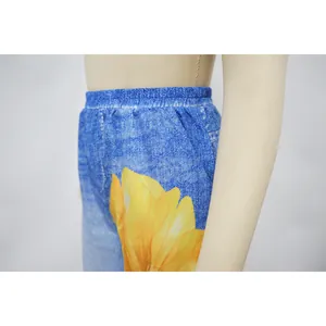 Macro detail view of casual wide-leg pants with sunflower print and comfortable elastic waist