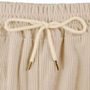 Detailed view of corduroy cargo shorts waist with elastic band and gold-tipped drawstrings