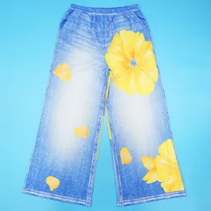 Detailed view of women's blue wide-leg pants featuring a vibrant yellow floral print