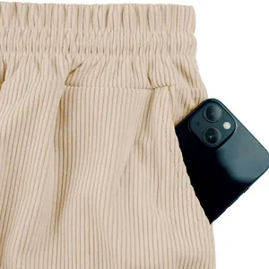 Detailed close-up of beige corduroy cargo shorts pocket showing fabric texture and utility