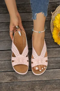 Stylish pink wedge sandals with laser-cut hollow patterns and 3D flower decorations