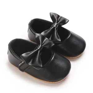 Detailed view of black baby girl soft sole walker shoes with large bow decoration