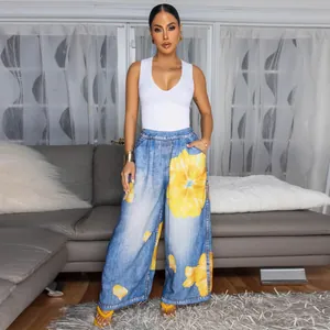 Women stylish casual wide-leg pants featuring vibrant yellow floral prints on denim look