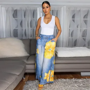 Detailed view of women's casual wide-leg trousers with vibrant yellow floral print