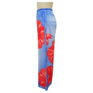Side view of stylish blue denim-print wide-leg trousers with large red floral patterns