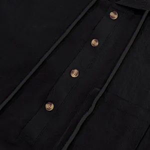 Close-up of textured black linen Henley shirt featuring marbled buttons and hooded drawstring
