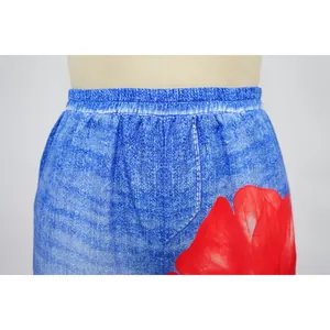 Close-up of high-waist elastic band on blue denim-print wide-leg trousers